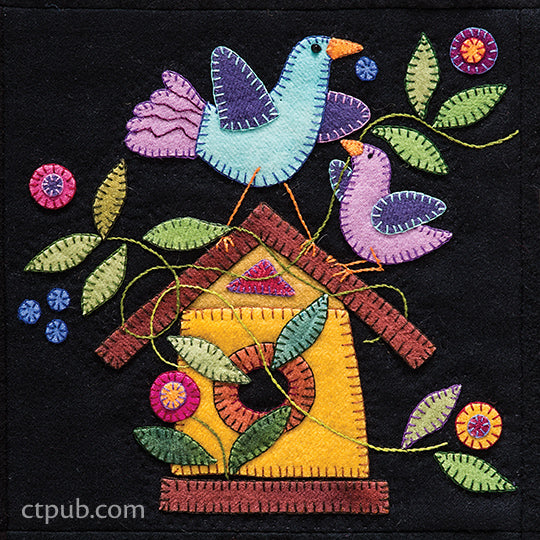Bring home the enchanting Summertime Sampler Print-on-Demand Edition by C&T Publishing, featuring a colorful wool appliqué design of two birds perched on a branch above a yellow birdhouse, all surrounded by hand-stitched green leaves and vibrant flowers atop a striking black background—the perfect summer accent for your décor.