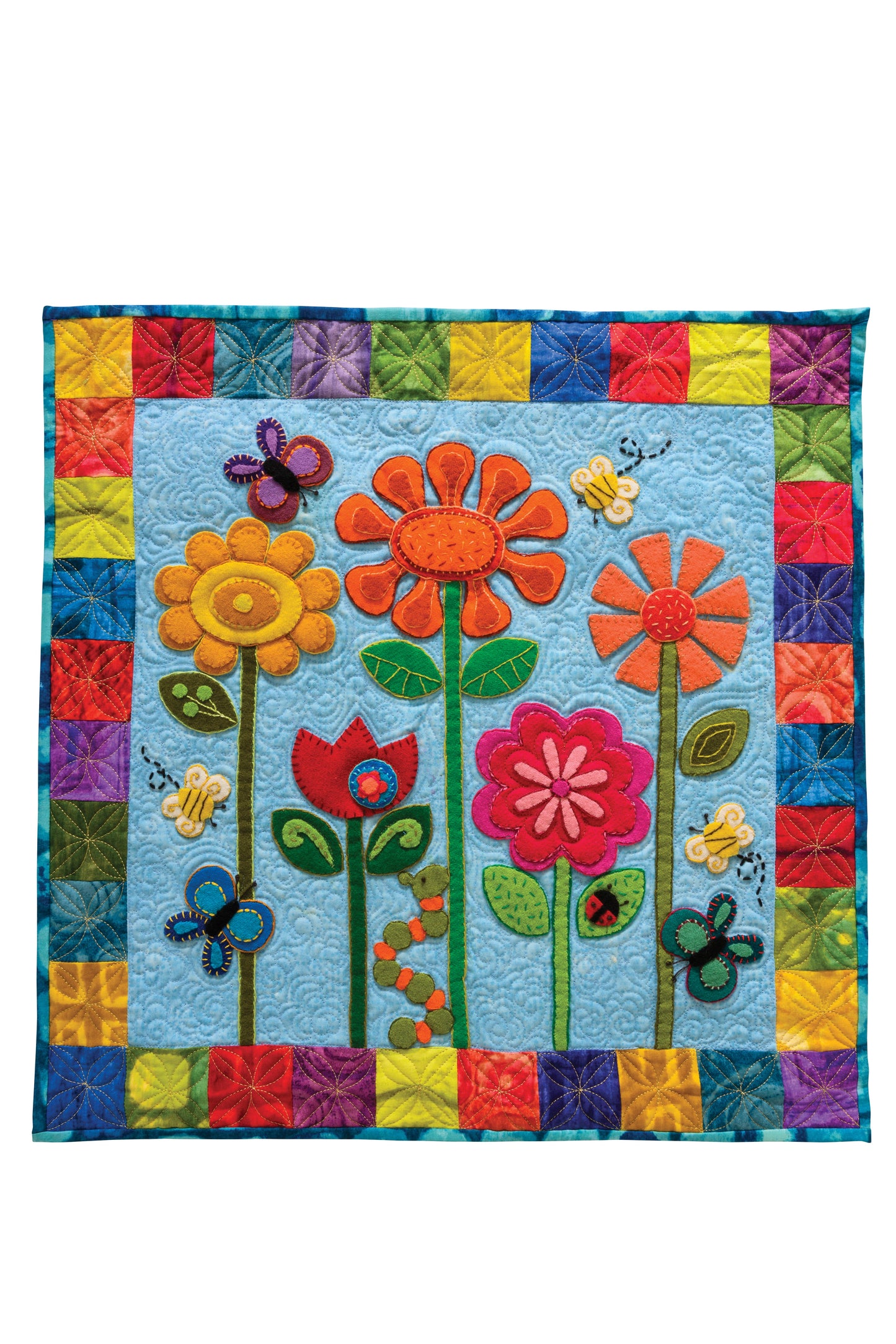 The Cool Cotton & Whimsical Wool Quilts Digital Download by C&T Publishing features bright appliquéd flowers, butterflies, and bees on blue with a patchwork border—ideal for beginner quilters seeking creative inspiration.