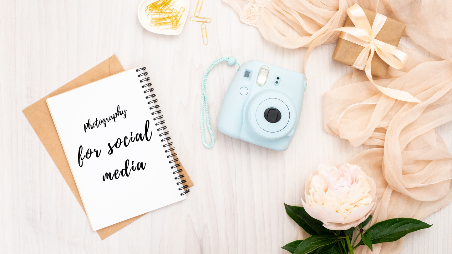 Flat lay featuring Creative Spark’s "Photography for Social Media" notepad, blue instant camera, gold paper clips, wrapped gift, peach fabric, and white peony—ideal for inspiring creative phone photography or learning the basics.