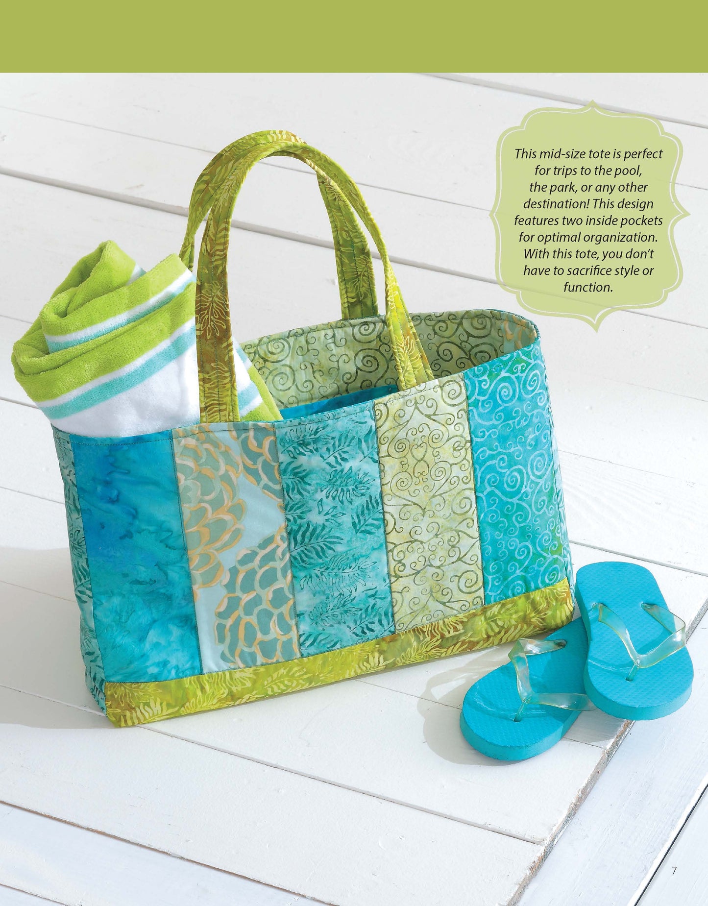 The “It’s in the Bag! Digital Download” by Leisure Arts features a colorful patchwork tote with green and blue designs on a white surface, holding a rolled towel, with turquoise flip-flops beside it—perfect for beginner sewing projects.
