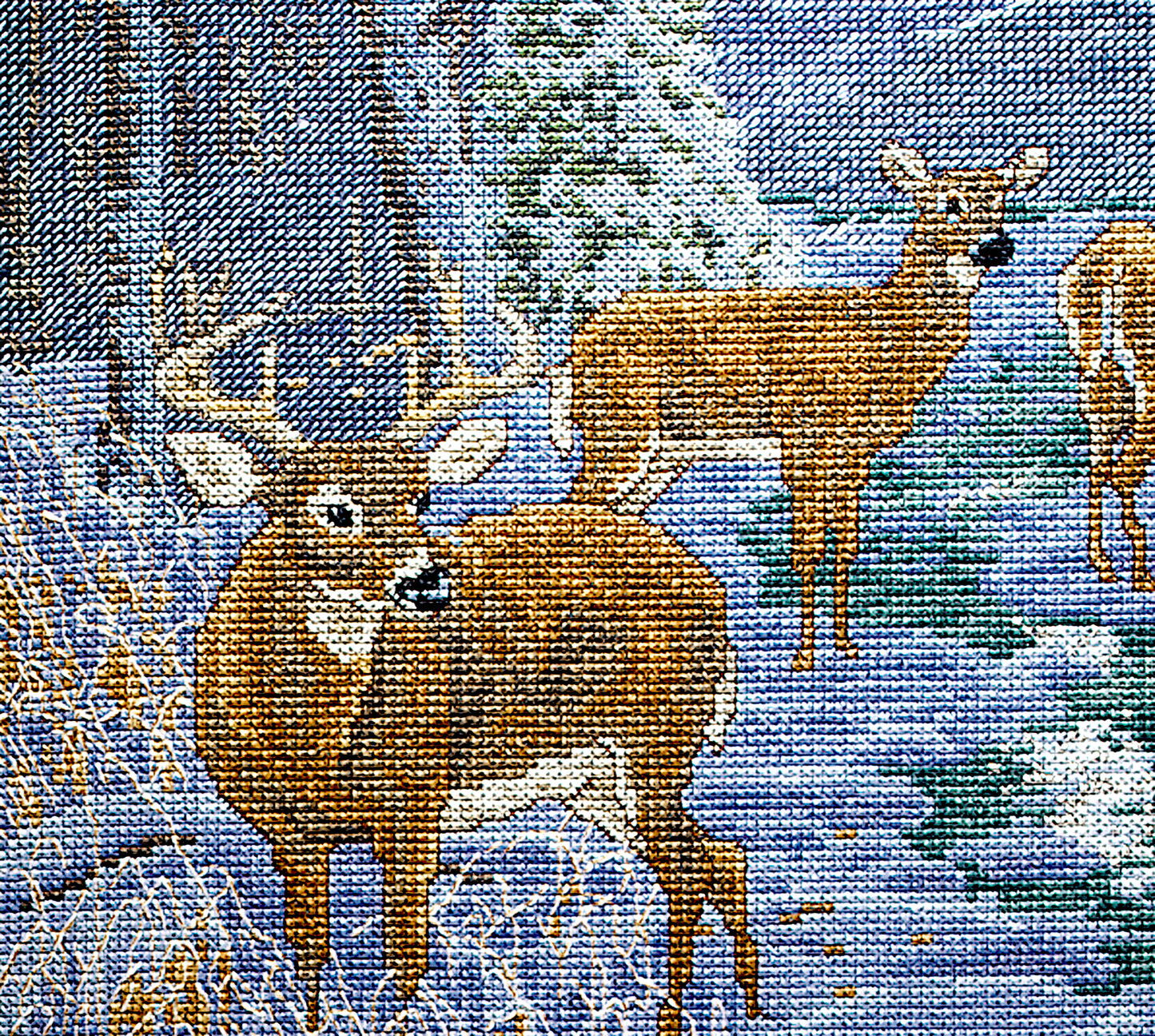 The Peace on Earth Cross Stitch by Leisure Arts features a woven tapestry of deer in a snowy forest, with a buck and two does detailed in brown, white, and blue threads—a perfect gift for nature lovers.
