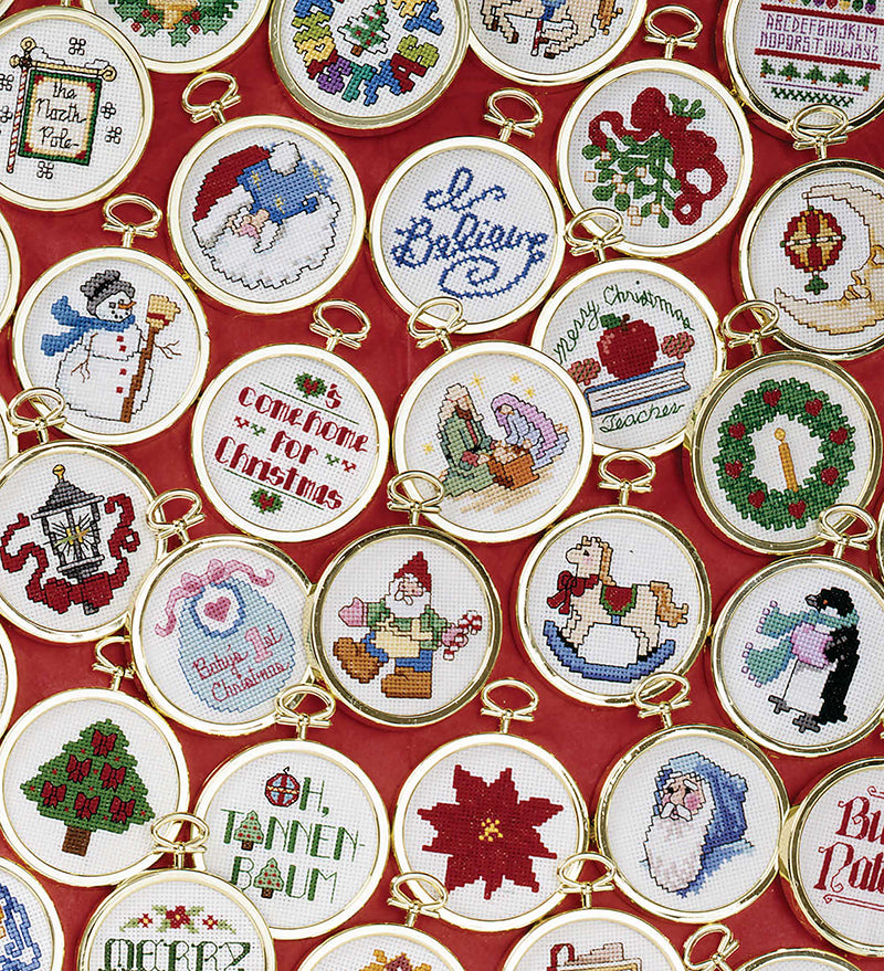 The 101 Christmas Minis Book 2 by Leisure Arts features festive round embroidery hoops with Santa, trees, wreaths, snowmen, and cheerful Christmas greetings—ideal for ornament cross stitch projects.