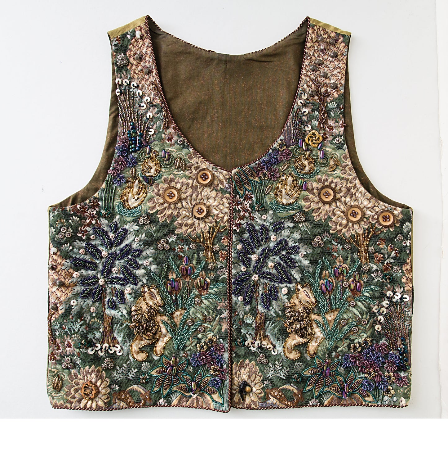 The Beaded Embroidery Handy Pocket Guide by C&T Publishing showcases various embroidery techniques, including floral patterns, sequins, and beaded designs with lions under palm trees on a green and brown fabric. Displayed flat on white.