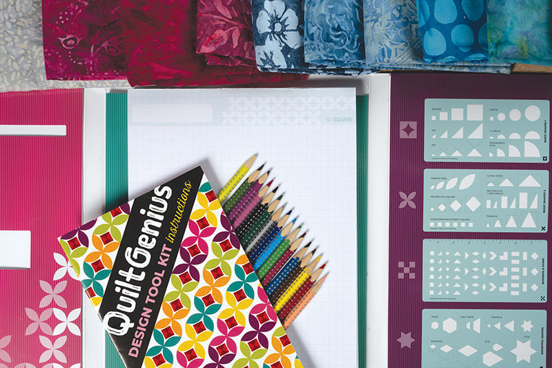 The C&T Publishing QuiltGenius Design Tool Kit includes patterned fabrics, colored pencils, a graph paper pad, instruction booklet, and quilt block templates—all neatly arranged for easy quilt designing.