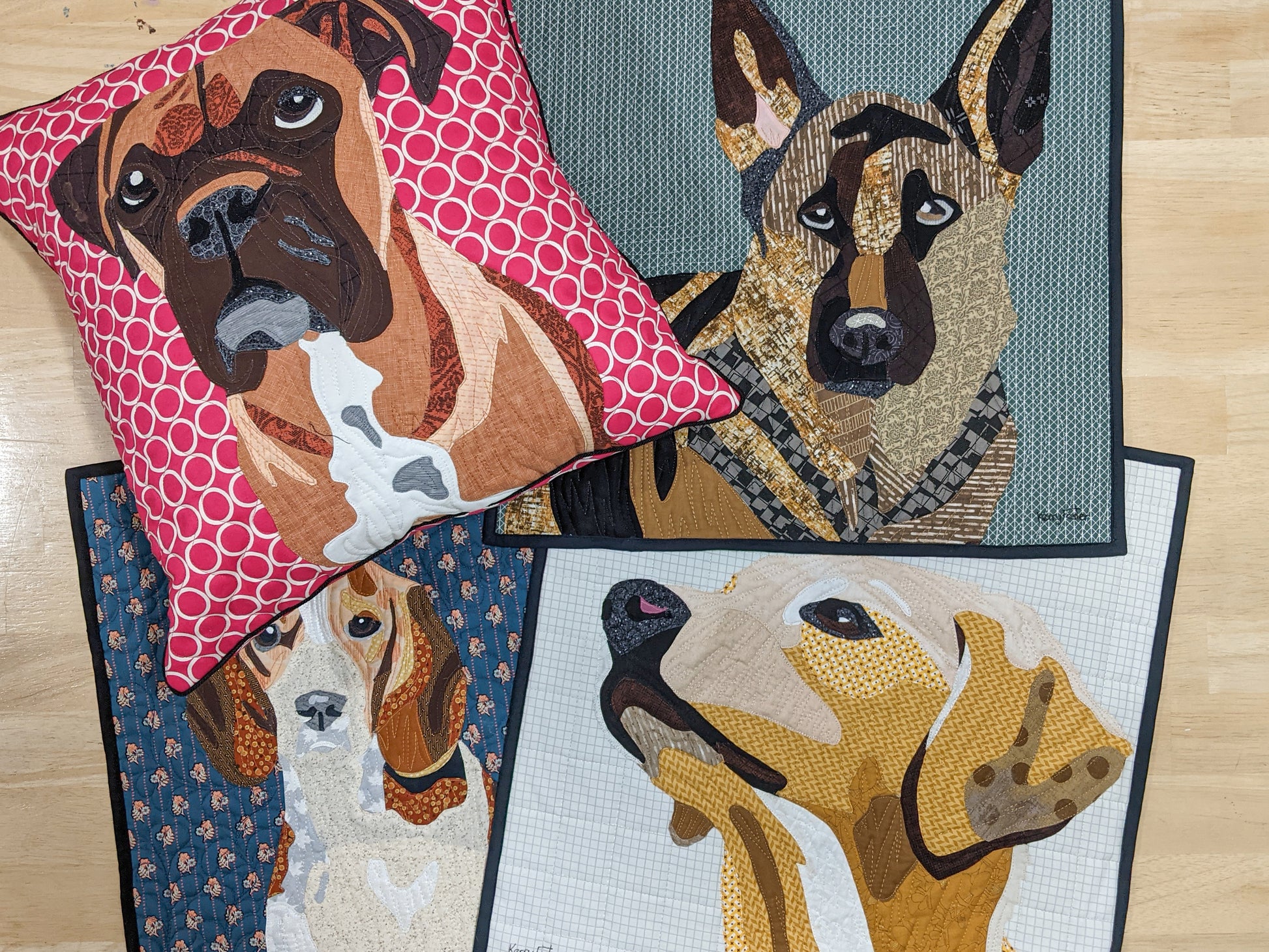 Four Creative Spark "Paint By Number Quilts: Dog Portraits" creations are shown: a brown boxer pillow (turned edge appliqué), a German shepherd wall quilt, and two mini quilts—a beagle and a yellow labrador retriever.