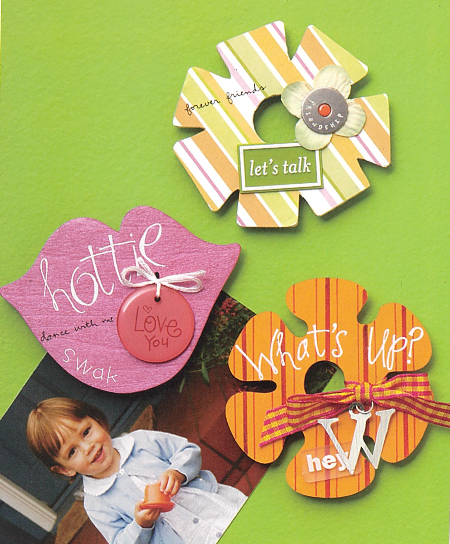 Three colorful magnets from The Ultimate Paper Crafts Collection by Leisure Arts display a child’s photo on a green surface, featuring playful phrases like "Let’s talk," "What’s up?", "hottie," and "Love You" in charming designs.