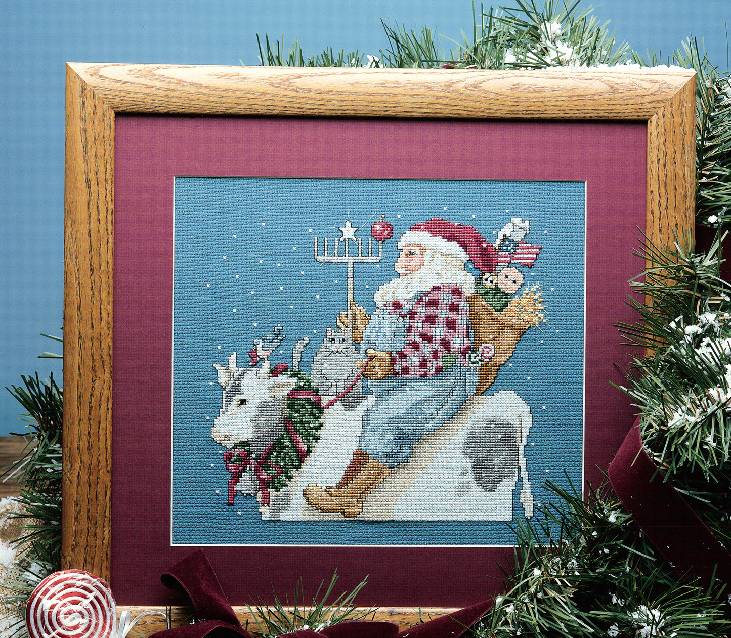 Get festive inspiration with Leisure Arts' "Santa's Great Book of Cross Stitch" digital download, featuring charming Christmas designs like Santa riding a cow with toys—perfect for your holiday cross stitching projects.