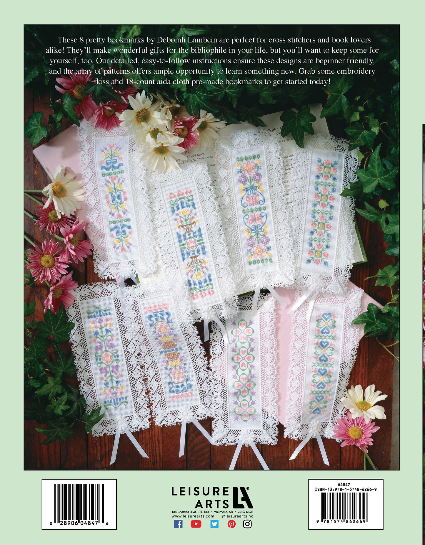 Cross Stitch Pretty Bookmarks by Leisure Arts are ten colorful floral and geometric bookmarks, stitched with embroidery floss on 18 count aida cloth, each bordered with white lace and ribbon and arranged in a fan shape on white fabric.