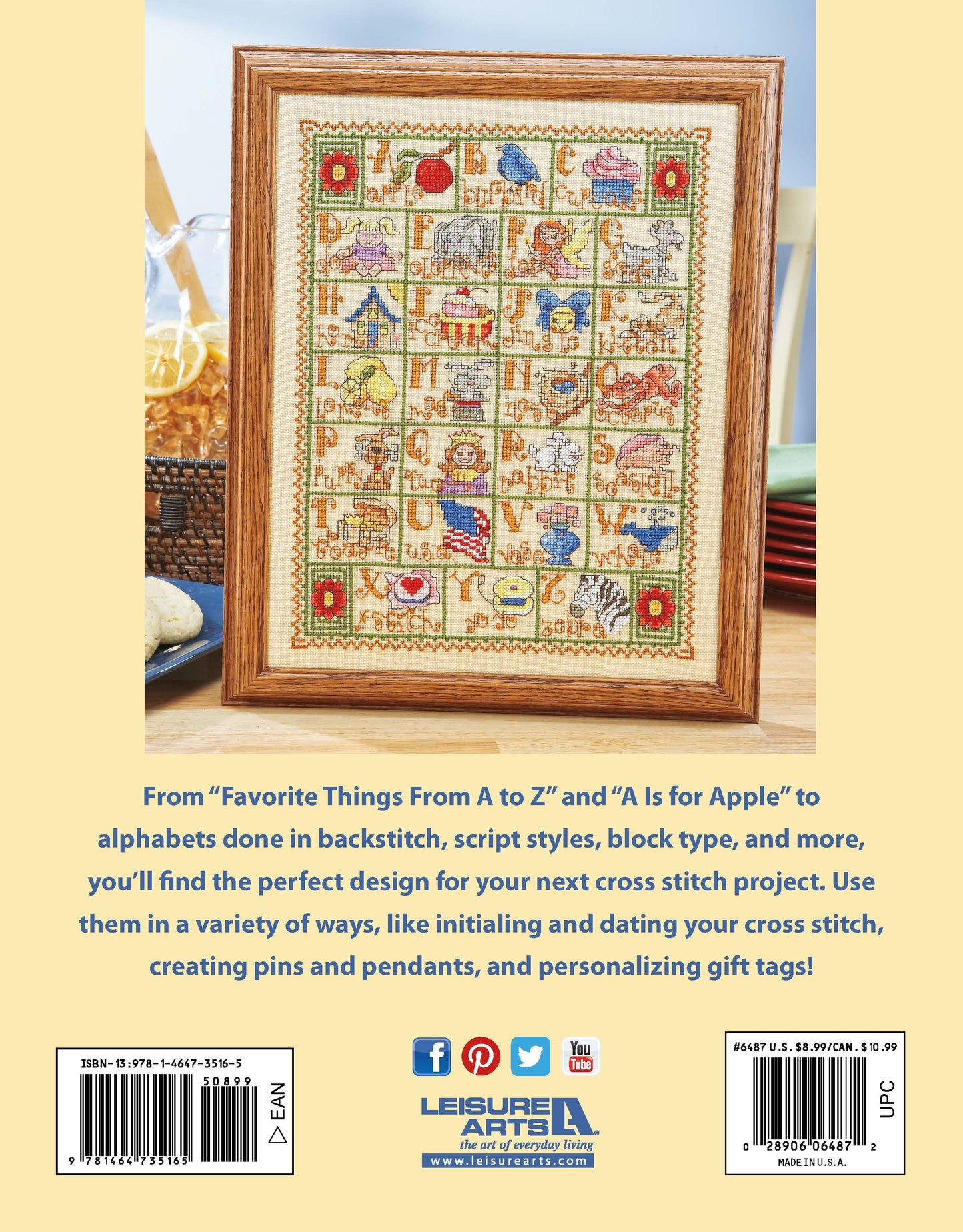A to Z Alphabets Cross Stitch by Leisure Arts features a framed sampler with colorful alphabet letters and images, displayed on a table with scissors and thread nearby. Text below highlights creative designs; Leisure Arts branding is at the bottom.
