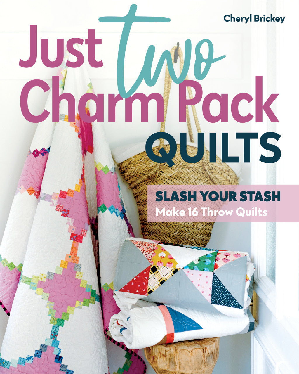 Book cover for Just Two Charm Pack Quilts by Stash Books, showing vibrant charm pack quilts with geometric designs draped over a wicker basket and white chair, with bold, colorful title text on the image.