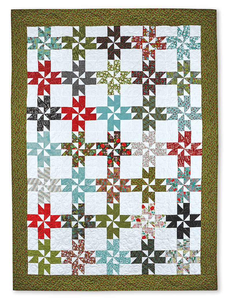 The Quilter's 2-1/2" Strip Precut Companion by C&T Publishing features a colorful pinwheel patchwork design in red, green, and blue with floral borders, ideal for beginner quilters.