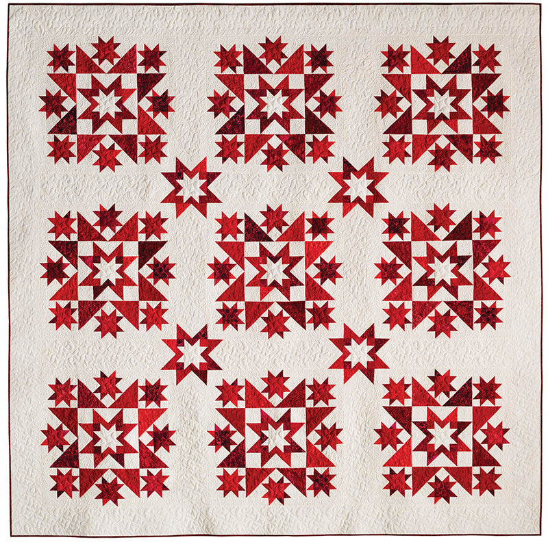 C&T Publishing’s Red, White & Blue Star Quilts features a white background with nine detailed, symmetrical red star patterns set in a 3x3 grid—evoking classic patriotic quilt designs with striking geometric beauty.