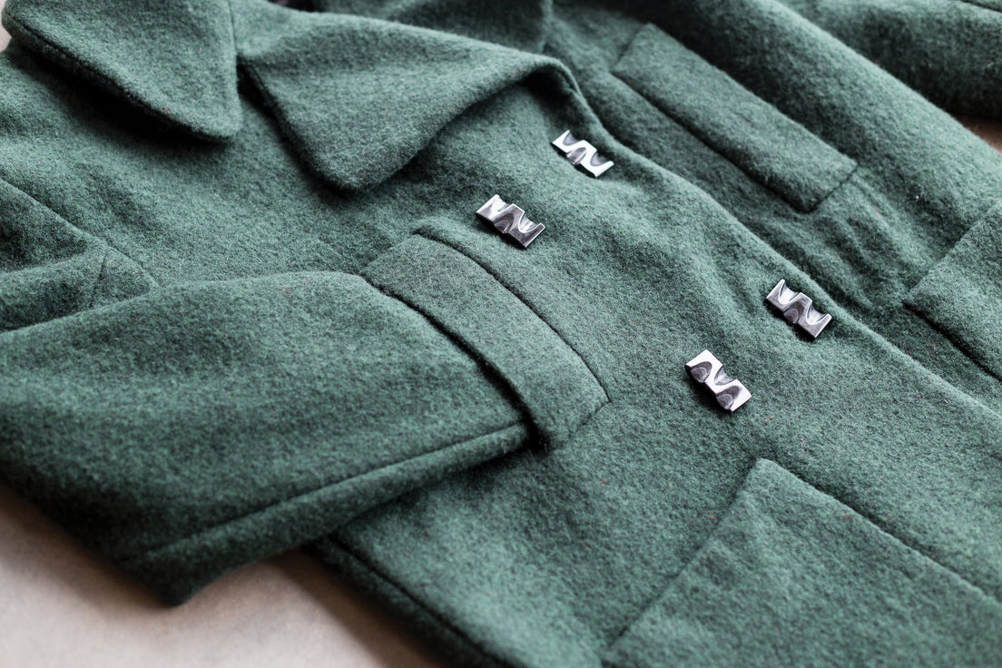 A close-up of Stress-Free Sewing Solutions by C&T Publishing, showing expert garment techniques in every detail—from textured fabric to precise finishes—for flawless results.