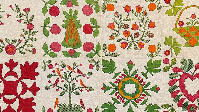 Discover “Red & Green Quilts: Historical Lecture” by Creative Spark—exploring vibrant quilts with intricate floral, fruit, and bird designs in red, green, orange, and pink squares on white, echoing rich quilt history.