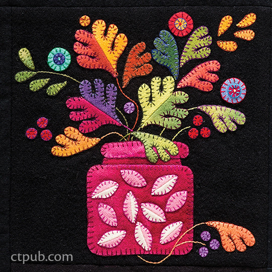 Summertime Sampler Print-on-Demand Edition by C&T Publishing showcases colorful, embroidered felt leaves and flowers in a vibrant pink vase set against a black background. Visible hand-stitched details evoke classic wool appliqué, while the vase and foliage feature lively, contrasting colors and playful patterns for a cheerful summer sampler look.