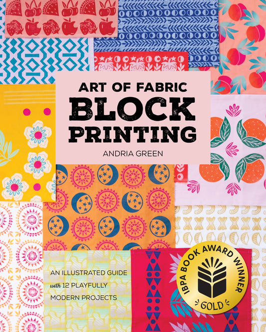 Book cover for Art of Fabric Block Printing by Stash Books showcases vibrant, patterned fabric swatches with hand-carved block designs. A gold IBPA Book Award Winner seal is at the bottom right. Subtext highlights 12 playful modern projects.