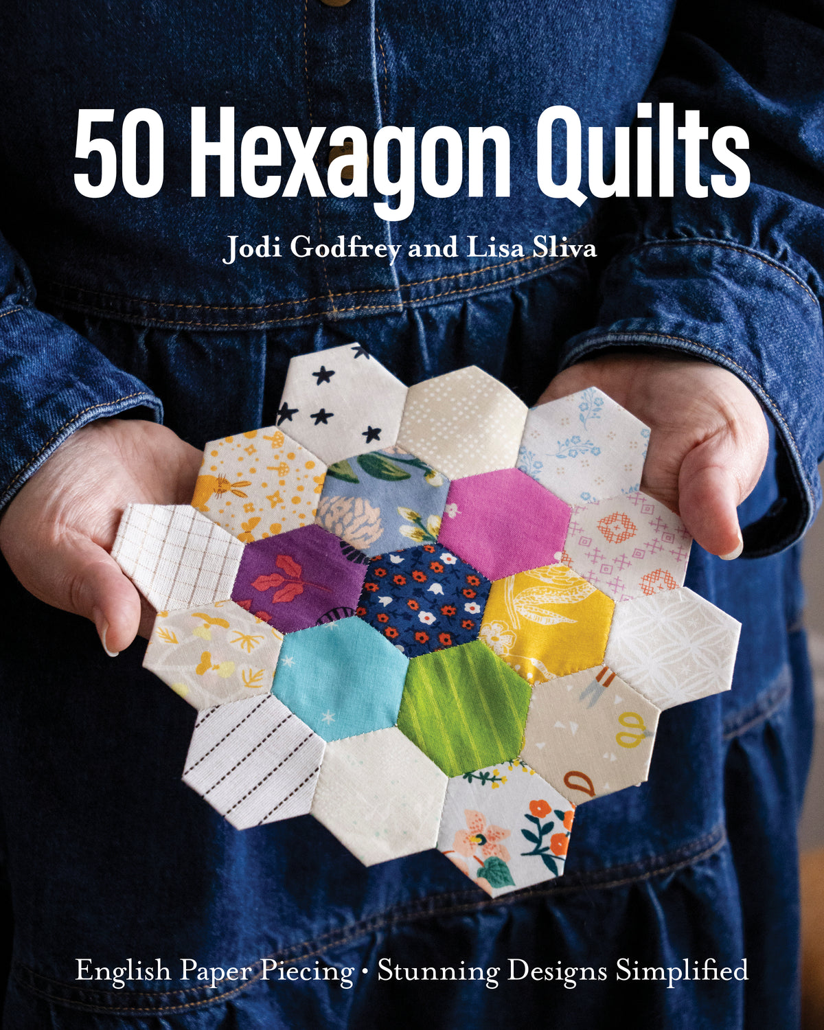 Hands holding a 50 Hexagon Quilts design featuring colorful, patterned fabric hexagons.