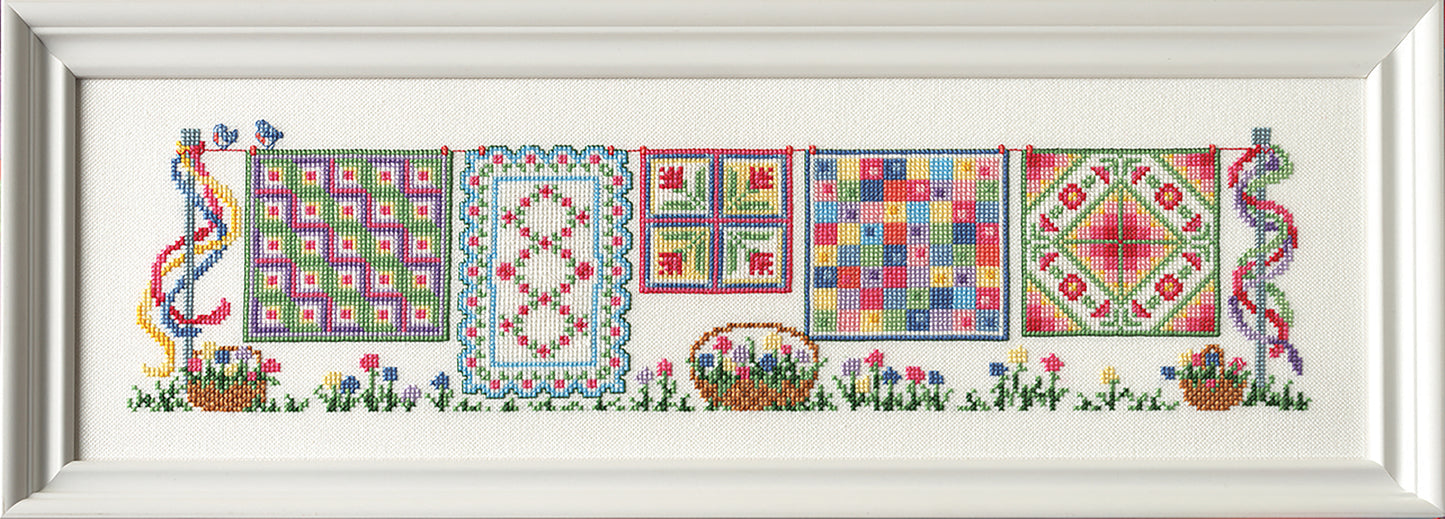 The "Five Seasons of Quilts" by Leisure Arts features five vibrant quilt patterns on a clothesline, framed by flowers, ribbons, birds, and baskets—a delightful décor piece for seasonal quilt lovers.
