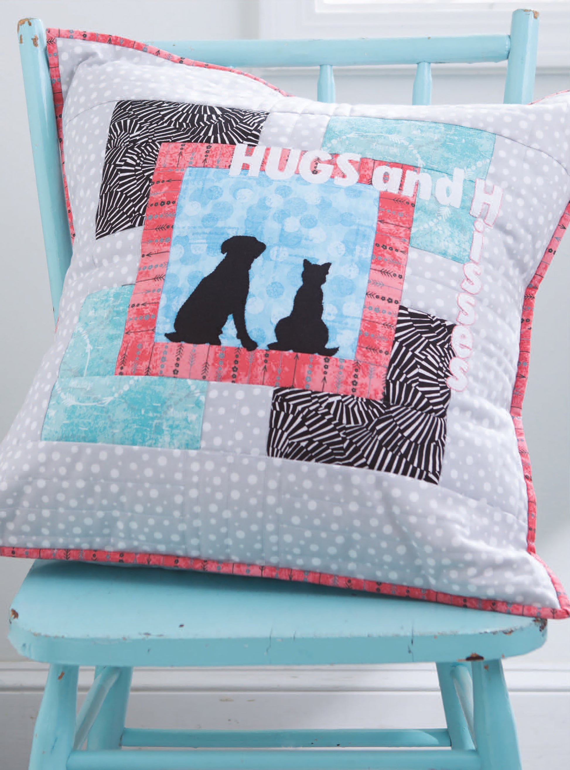 The City Blocks digital download by Leisure Arts features 32 pieced and applique blocks portraying city life, including colorful patchwork squares and animal silhouettes, displayed on a light blue wooden chair.