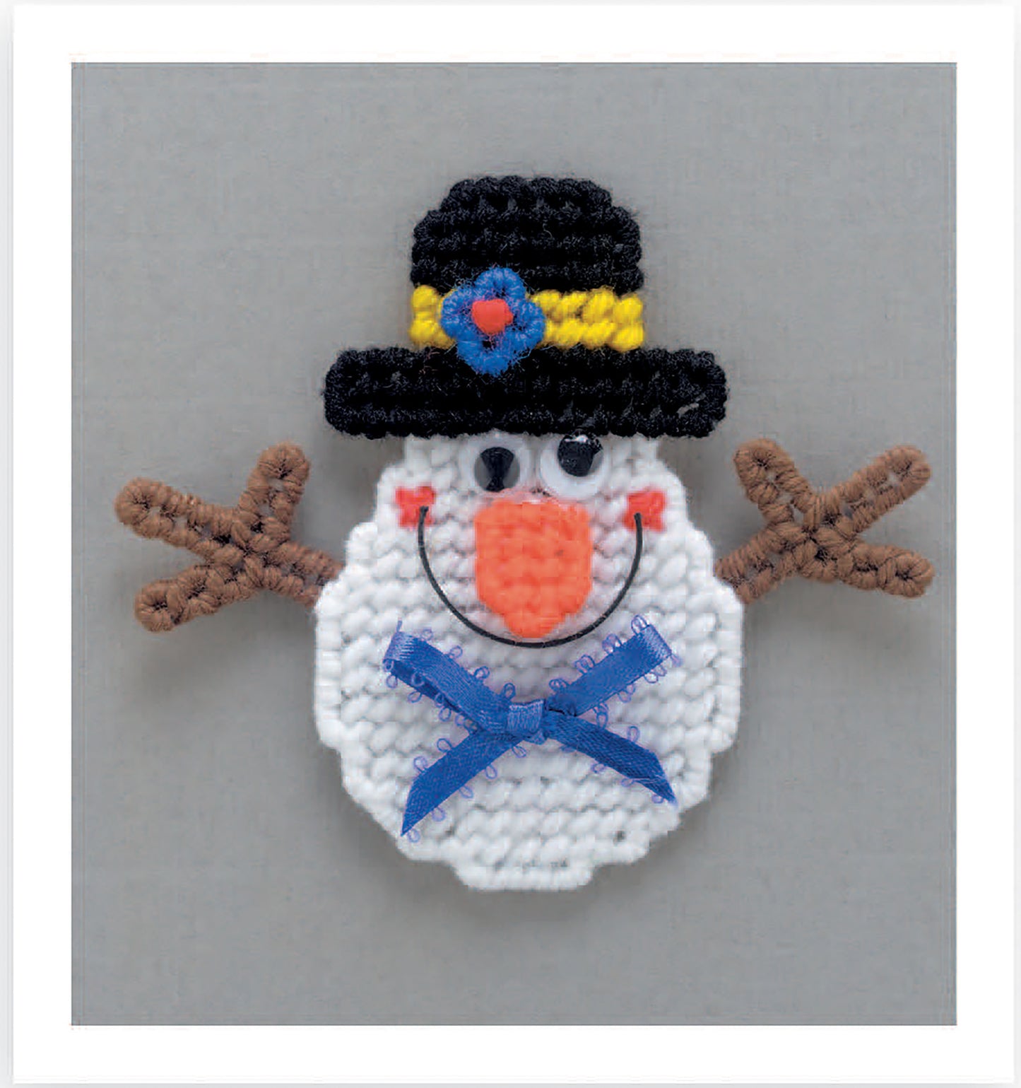Create a beginner-friendly crocheted snowman face magnet featuring a black hat, colorful bands, googly eyes, and more—designed for Magnet Board Creations in Plastic Canvas by Leisure Arts. Digital download.