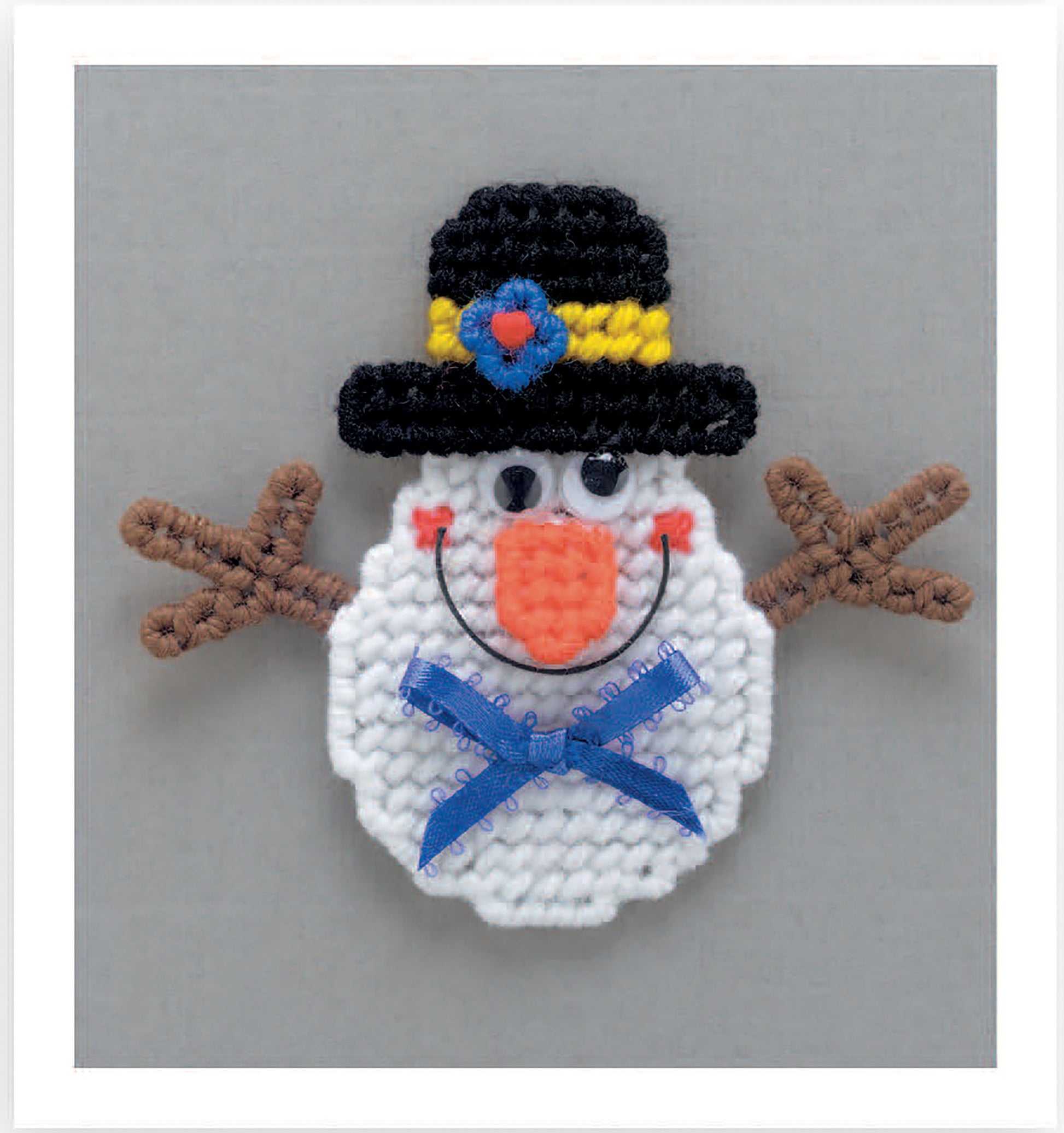 Create a beginner-friendly crocheted snowman face magnet featuring a black hat, colorful bands, googly eyes, and more—designed for Magnet Board Creations in Plastic Canvas by Leisure Arts. Digital download.