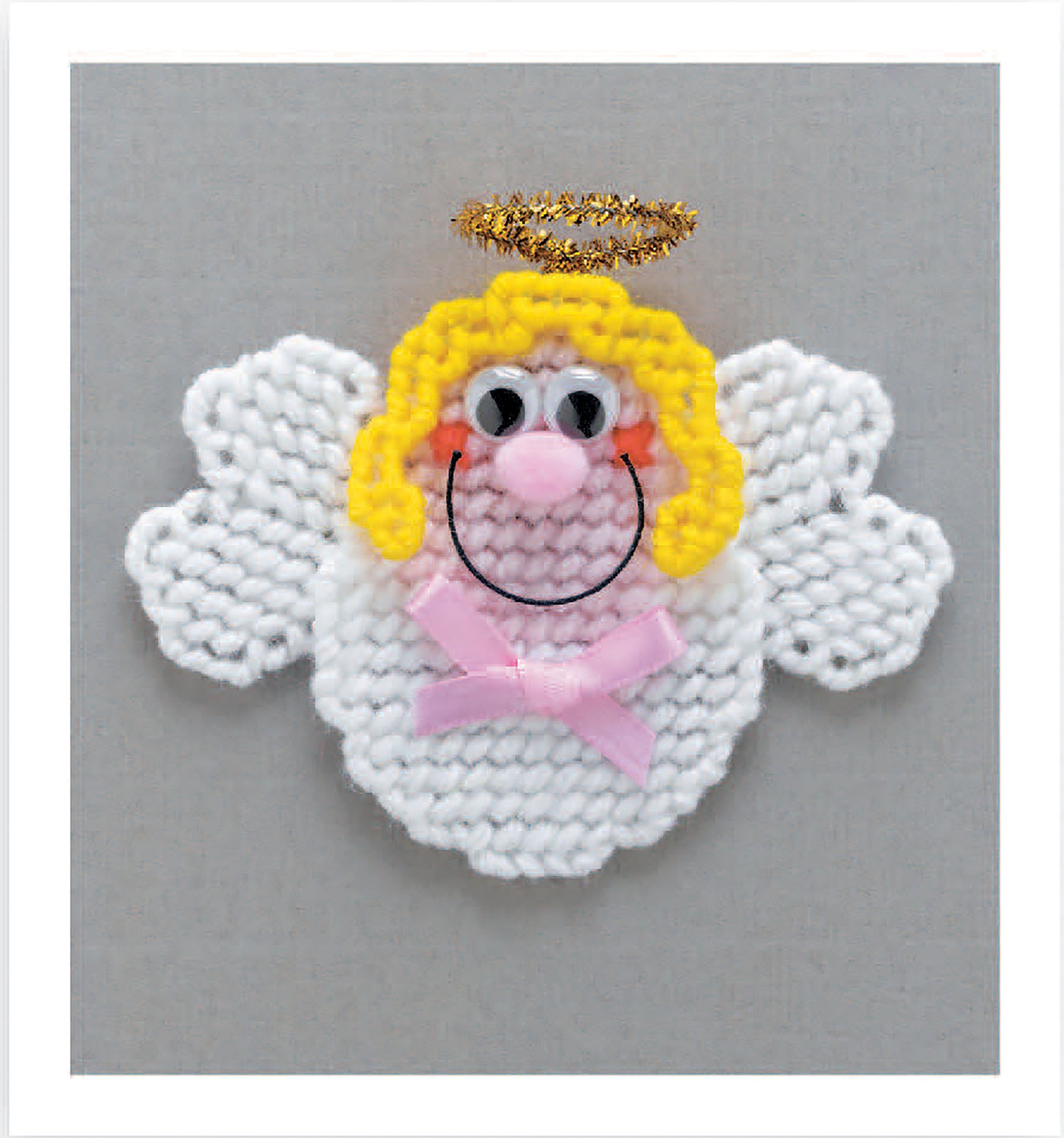 Leisure Arts' Magnet Board Creations in Plastic Canvas Digital Download offers beginner-friendly handmade designs, featuring cute details like yarn hair, a gold halo, googly eyes, and ribbon bows—all displayed on a gray background.