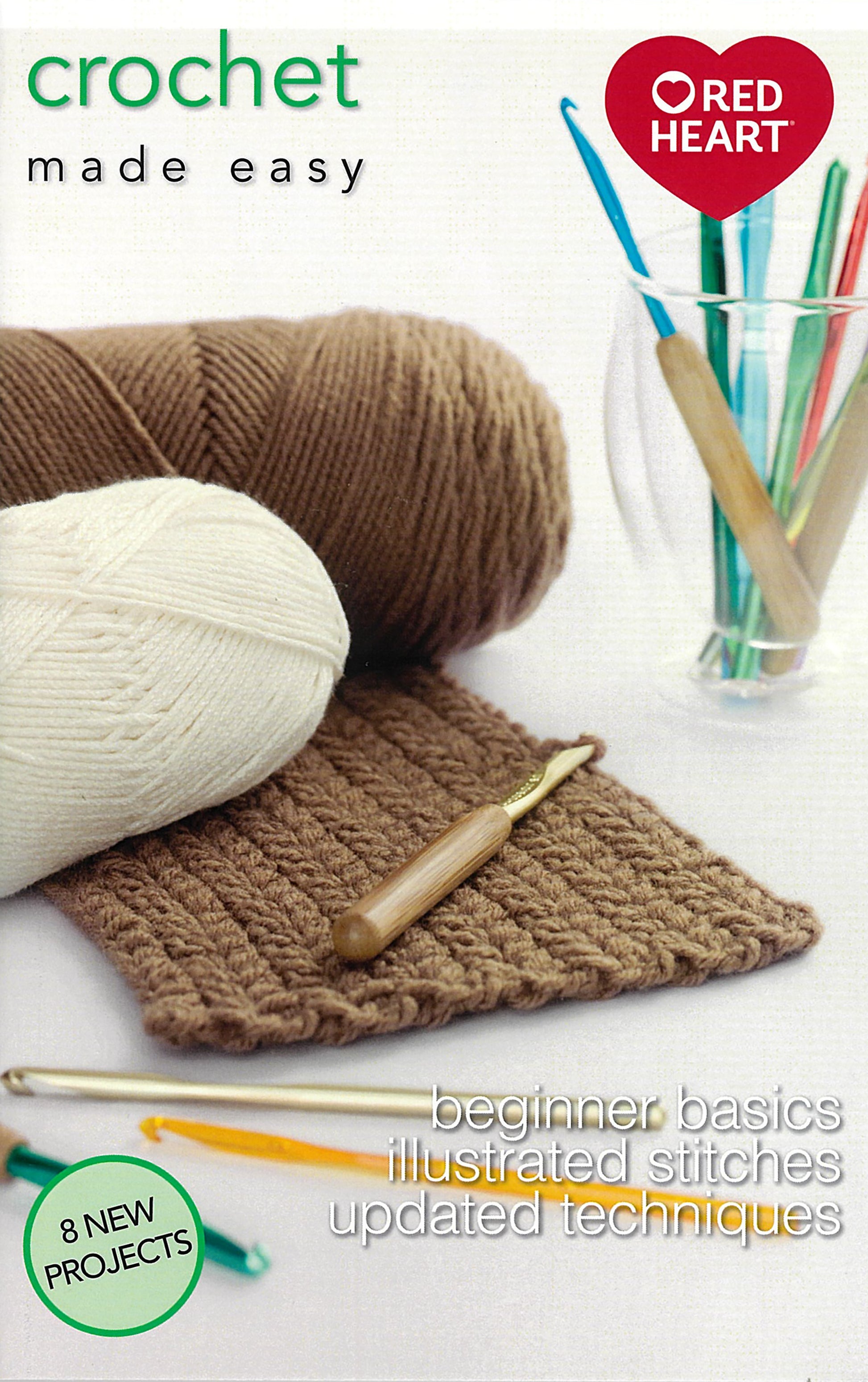 The cover of Crochet Made Easy by Leisure Arts features brown and white yarn, three crochet hooks, a swatch, a glass with hooks, and text highlighting beginner basics and 8 projects.