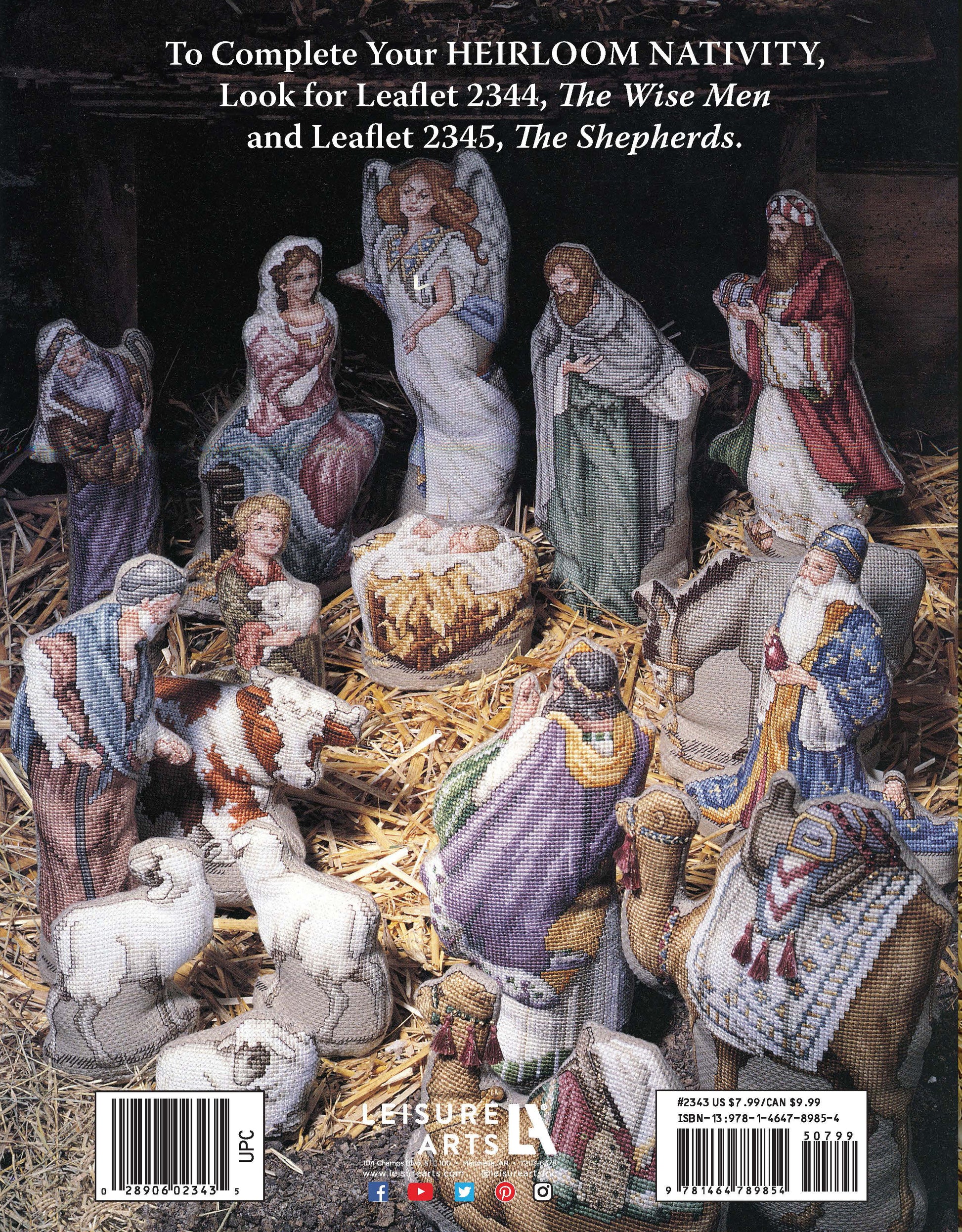 The Holy Family Heirloom Nativity Book 1 by Leisure Arts features cross-stitched figures of Mary, Joseph, baby Jesus, shepherds, wise men, angels, and animals arranged in a stable scene. Collectible leaflet info appears at the top.