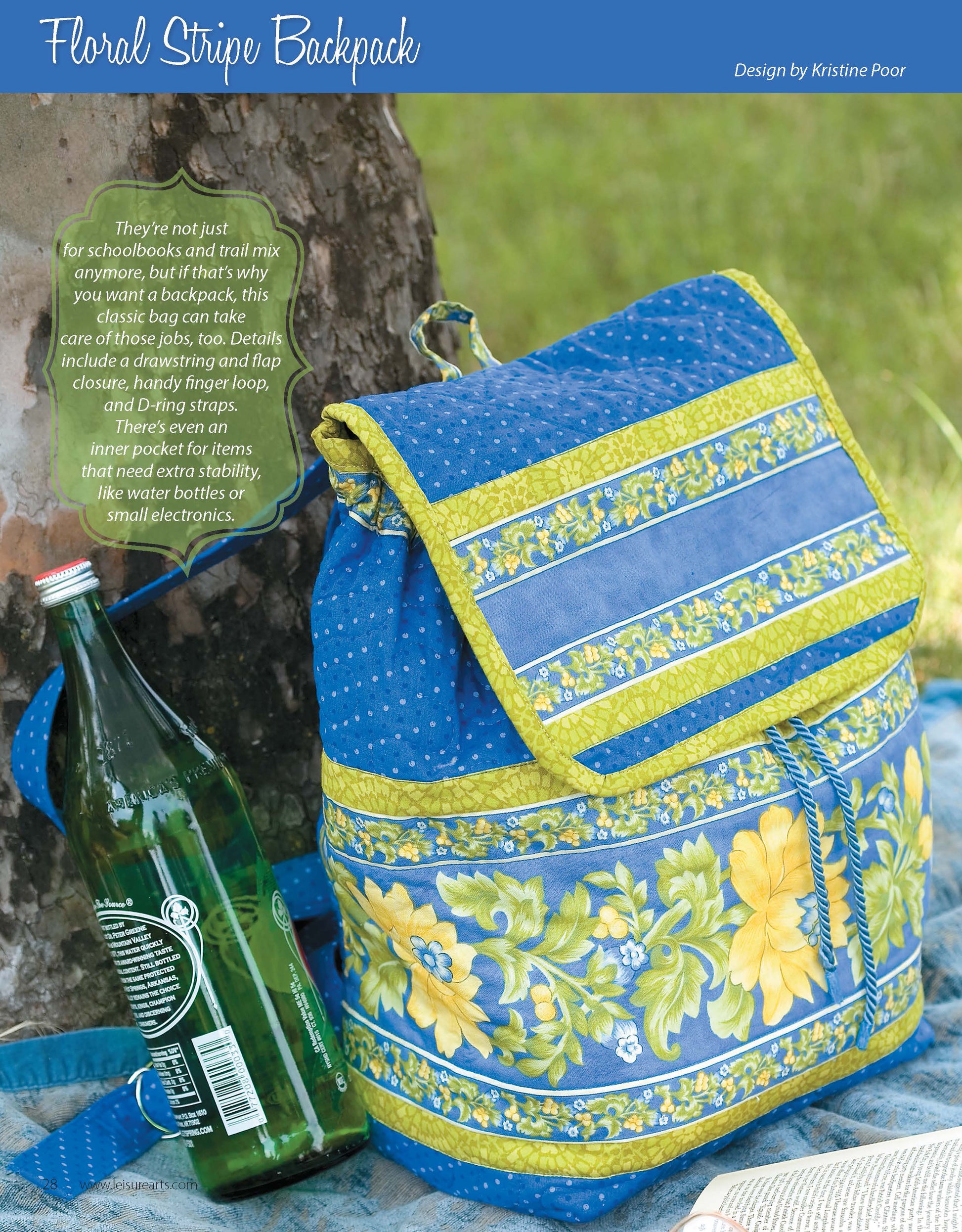 The "It's in the Bag! Digital Download" by Leisure Arts shows a blue and yellow floral-striped backpack with a front pocket and drawstring, resting on grass near a tree with a green bottle and plaid cloth—ideal for beginner sewing projects.