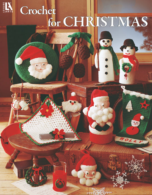 Crochet for Christmas by Leisure Arts showcases crochet Santa figures, snowmen, stockings, wreaths, an afghan, and ornaments in worsted weight yarn—festive home decor arranged with a wooden chair and table for cozy holiday charm.