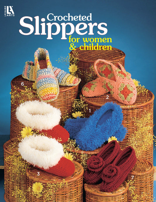 Six pairs of Leisure Arts Crocheted Slippers for Women & Children, each with unique textures and patterns, are displayed in woven baskets with yellow flowers. Text above reads: Crocheted Slippers for Women & Children.