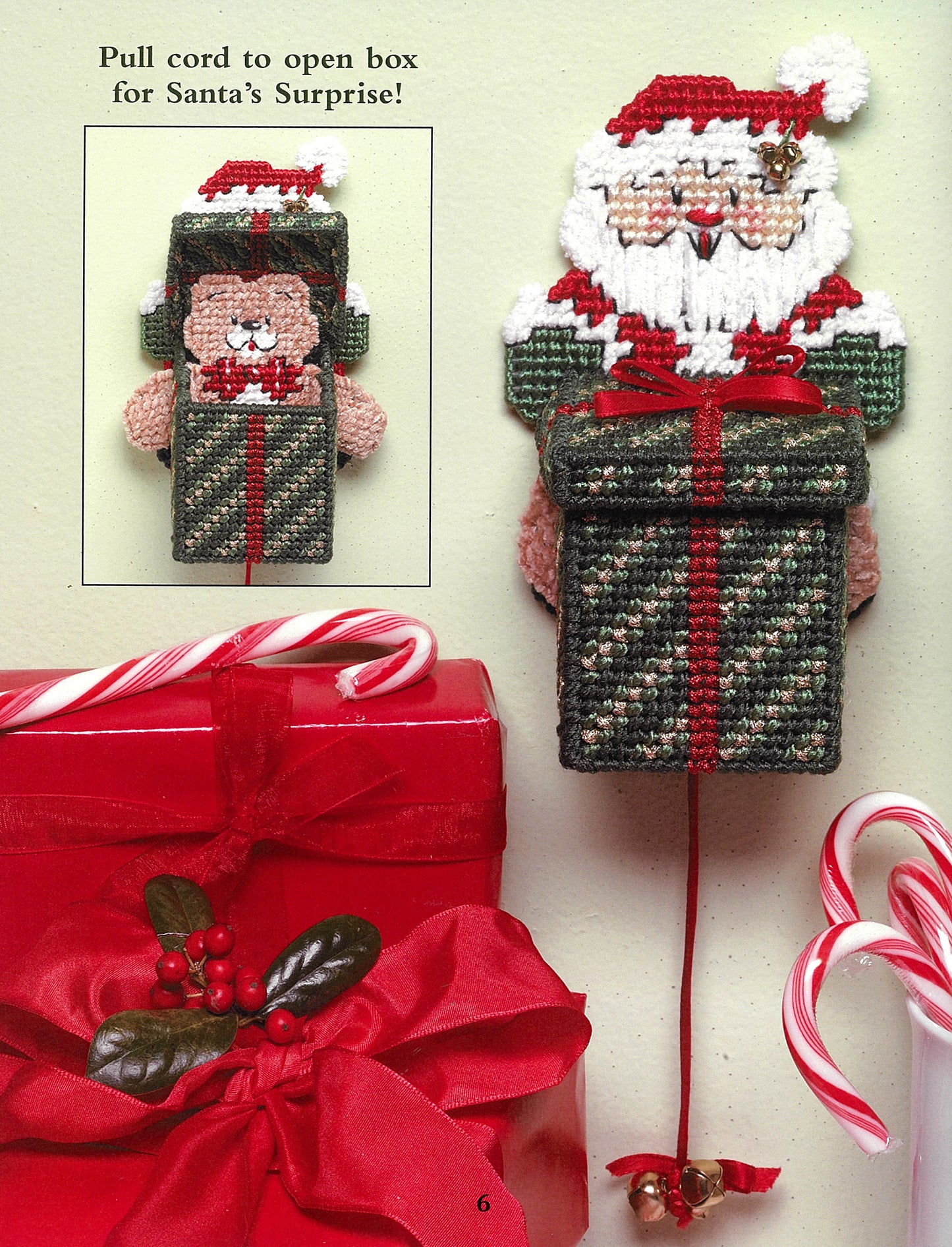 The "Santa, Bears, & Bells in Plastic Canvas" by Leisure Arts is a beginner-friendly decorative wall hanging for holiday crafts, featuring Santa with a green and red box, ribboned gift box, and candy canes for festive charm.