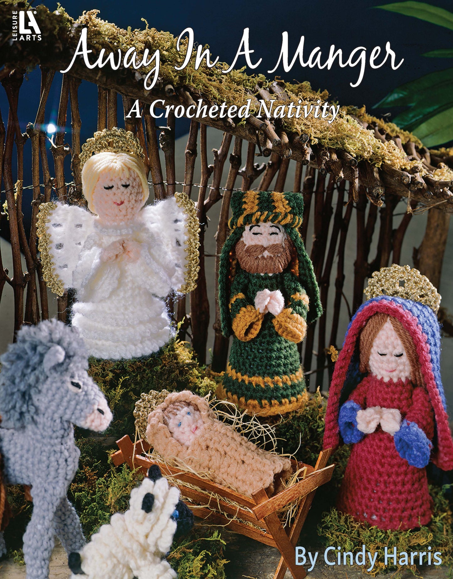 Cover of Away in a Manger—A Crochet Nativity by Leisure Arts, showing a crocheted nativity scene with Mary, Joseph, baby Jesus in a manger, an angel, donkey, and another figure made from worsted weight yarn in a stable.