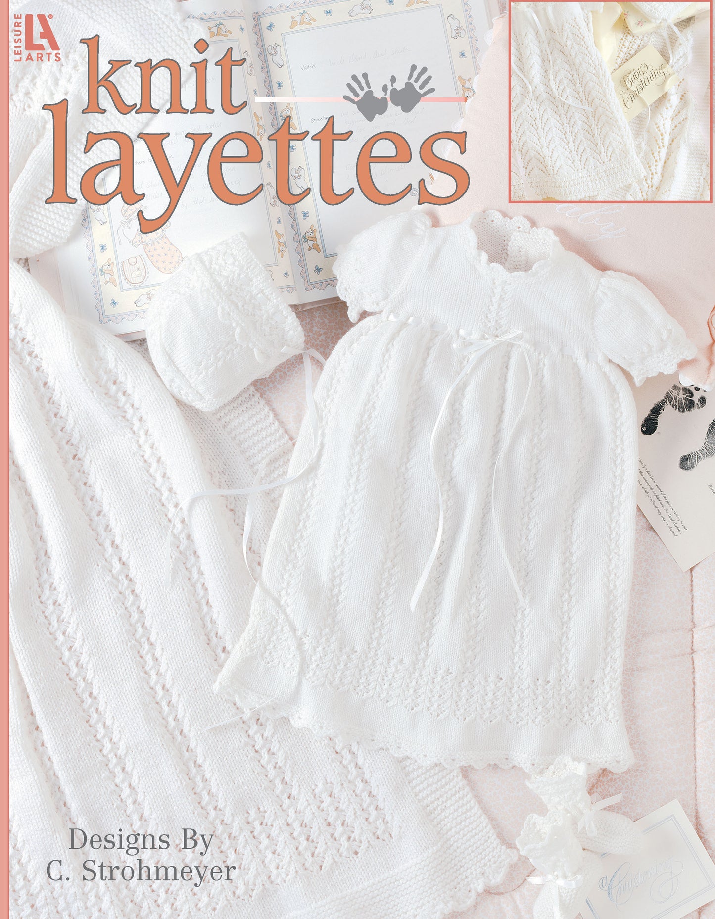 Cover of Leisure Arts' Knit Layette Digital Download, showcasing a delicate white newborn knit gown, bonnet, and booties set made with super fine yarn on a pastel background. Patterns designed by C. Strohmeyer.