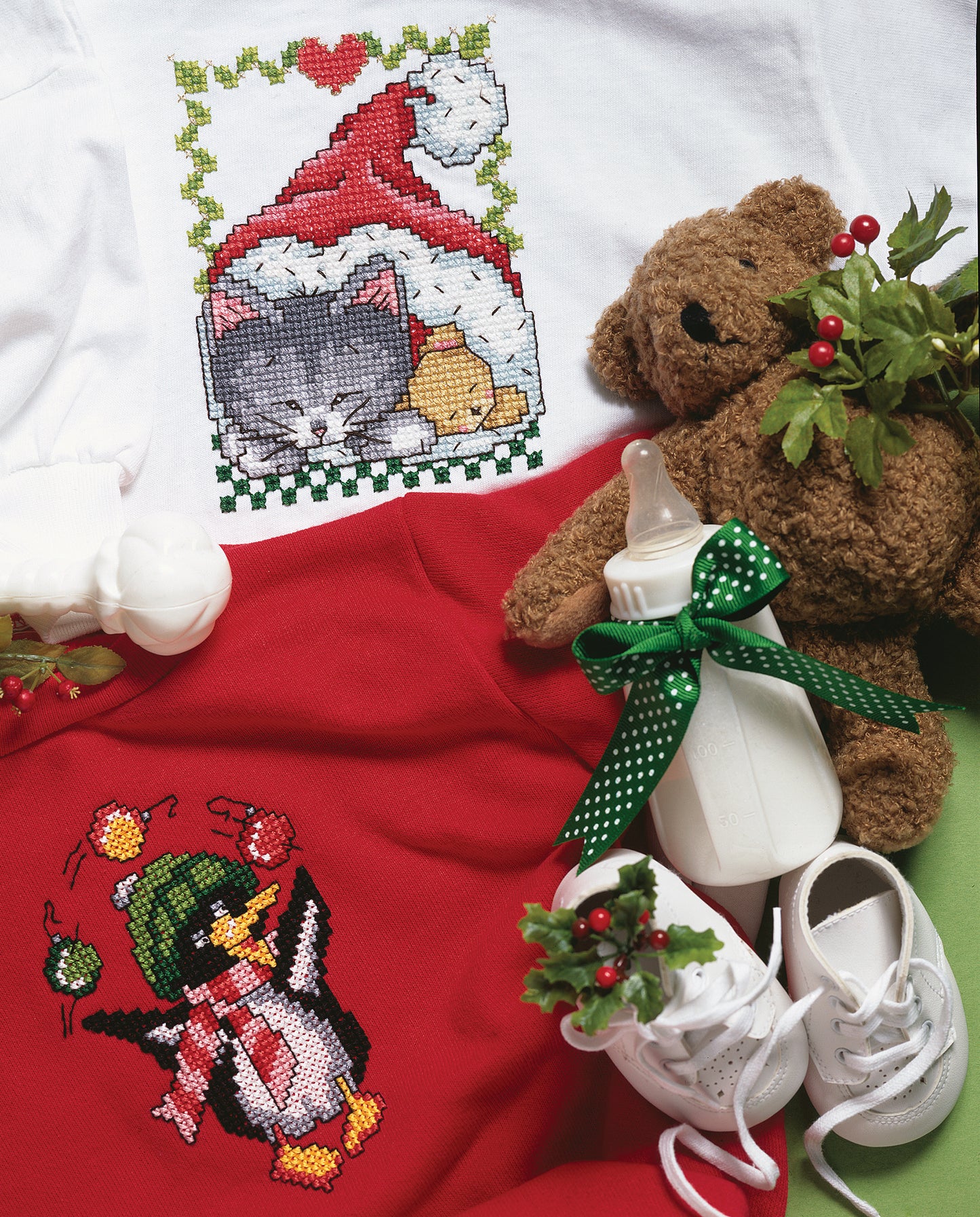 Bring festive cheer with Leisure Arts' "Embroider Fast & Festive 50 Christmas Designs" digital download, featuring beginner cross-stitch patterns like a sleeping cat in a Santa hat and a penguin in a winter cap—perfect for holiday projects.