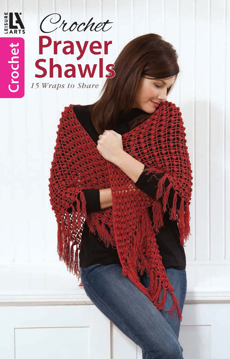 A woman in a black shirt wraps a red fringed shawl around her shoulders. Above her, "Crochet Prayer Shawls" by Leisure Arts is shown, offering 15 beautiful crochet patterns perfect for heartfelt, handmade gifts.