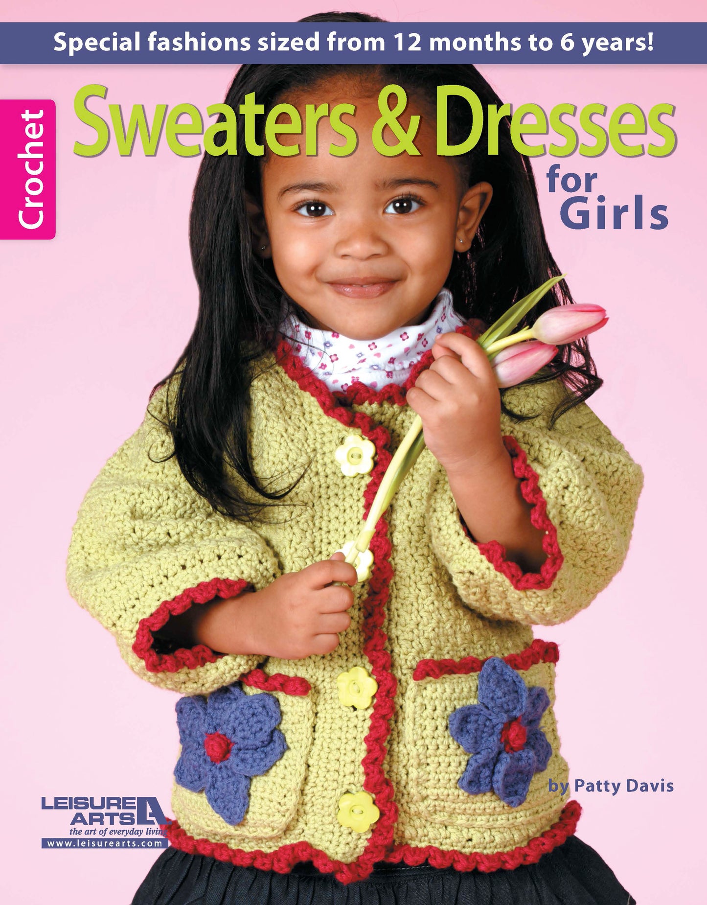 A young girl in a yellow crocheted sweater holds a pink tulip and smiles. The book cover reads Crochet Sweaters & Dresses for Girls by Leisure Arts, featuring handmade crochet designs for girls ages 12 months to 6 years.