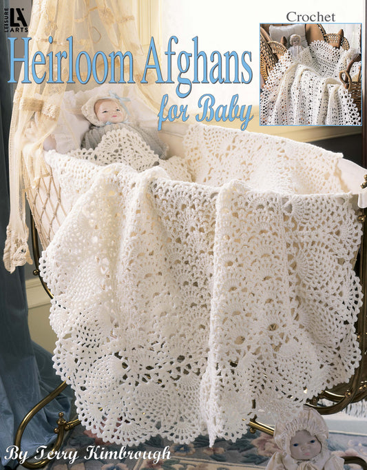 A delicate white crocheted afghan from “Heirloom Afghans for Baby” by Leisure Arts drapes over a vintage bassinet, surrounded by lace curtains and antique dolls, showcasing timeless design and intricate crochet stitches.