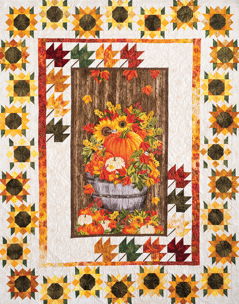 C&T Publishing's Quilt Panel Magic features a central panel with pumpkins, sunflowers, and autumn leaves in a wooden bucket, bordered by warm fall colors—ideal for panel quilts or using step-by-step instructions.
