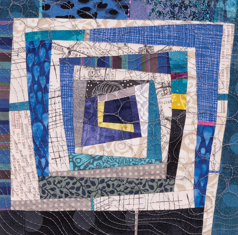 A close-up of a quilt square from Quilt Small, Dream Big by C&T Publishing highlights a spiraling pattern in blue, gray, white, and yellow prints—ideal inspiration for beginner quilters or miniature piecing enthusiasts.