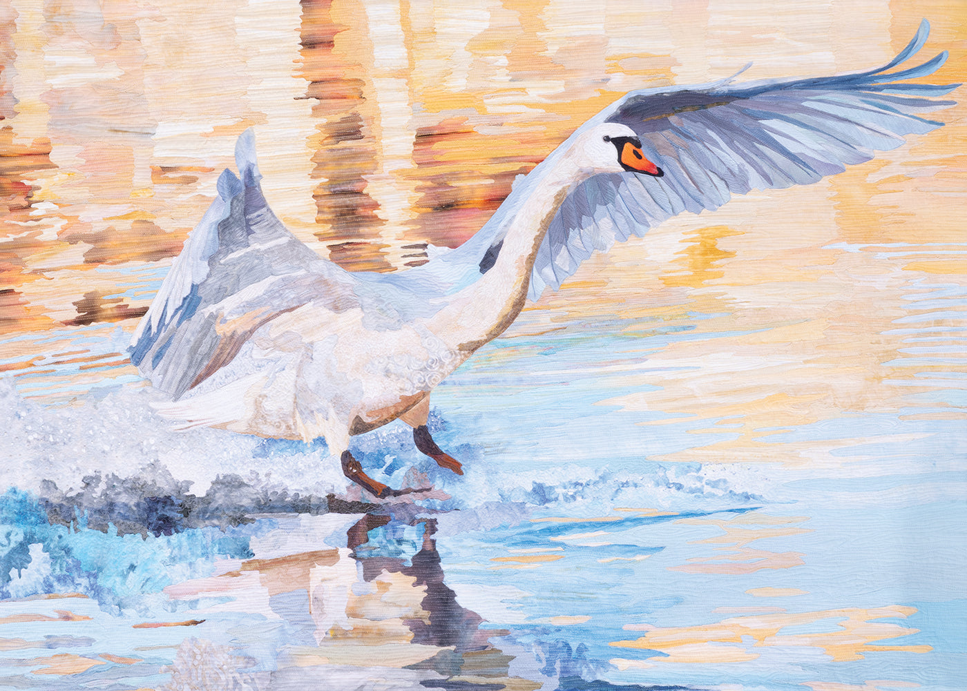 Experience “Quilted Realism” by C&T Publishing—a painting of a swan with wings outstretched, skimming the surface of calm water. Warm golden and orange background tones are depicted with quilted realism, beautifully evoking the intricate textures and layered artistry reminiscent of an exquisite art quilt.
