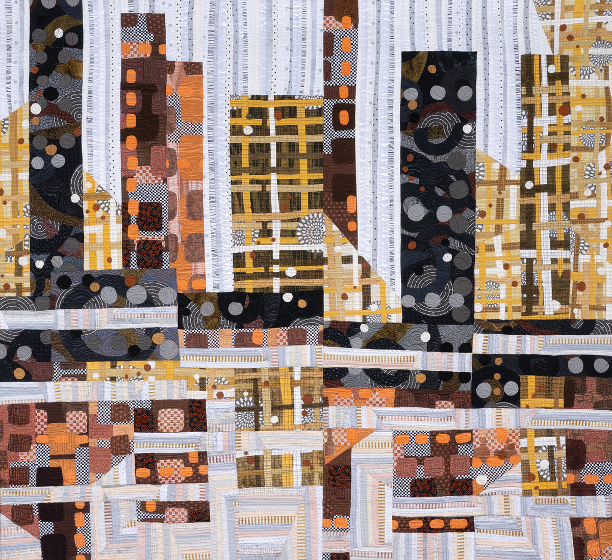 Inspiration in Color & Cloth—The Art Quilts of Katie Pasquini by C&T Publishing features abstract quilt designs in brown, black, orange, and white with city skyline shapes and textured patterns for an artistic look.