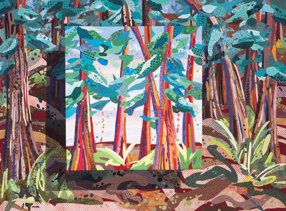 A vibrant quilted art piece from C&T Publishing’s Inspiration in Color & Cloth—The Art Quilts of Katie Pasquini features stylized trees in blues, greens, and reds framed by a colorful forest patchwork background.