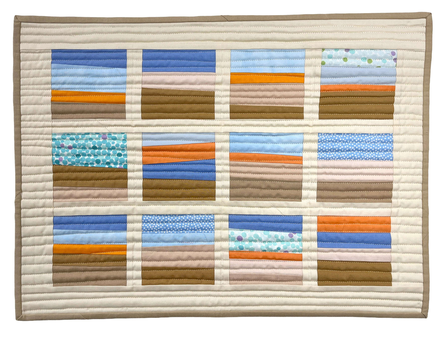 Create stunning décor with Creative Spark’s "Landscapes as Building Blocks: Quilt the Places You Love with Easy Improv"—a quilted wall hanging featuring twelve scenic panels, cream borders, and tan binding using scrap-friendly techniques.