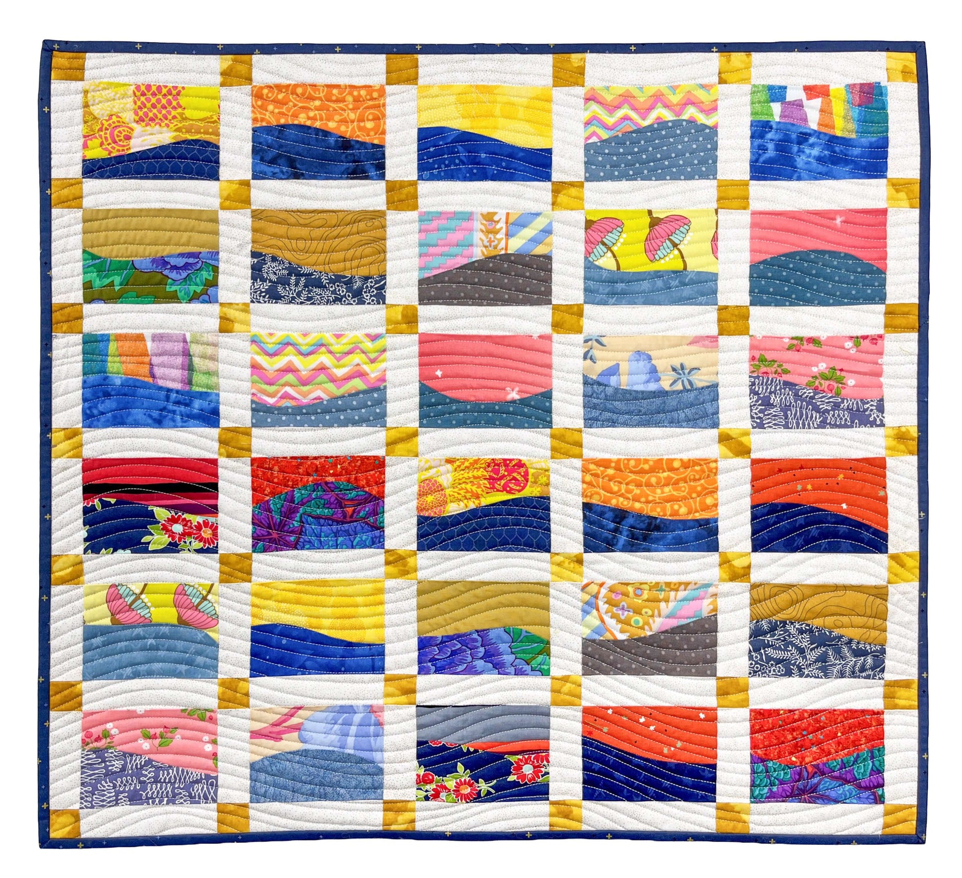 The “Landscapes as Building Blocks: Quilt the Places You Love with Easy Improv” by Creative Spark is a colorful quilt of 25 squares in blue, orange, yellow, pink, and floral prints with wavy stitching and white-gold sashing.