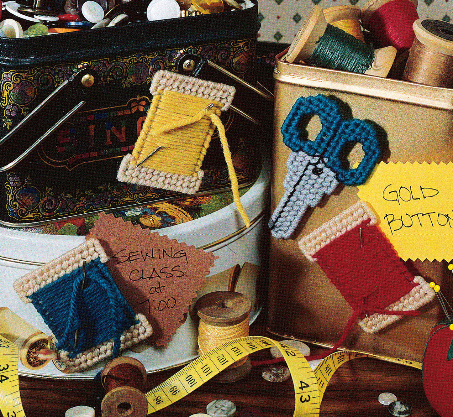 The "300+ Magnets in Plastic Canvas" by Leisure Arts offers a variety of sewing supply designs—like yarn-wrapped spools, crocheted scissors, threads, buttons, and tape—ideal for crafting magnetic accents.