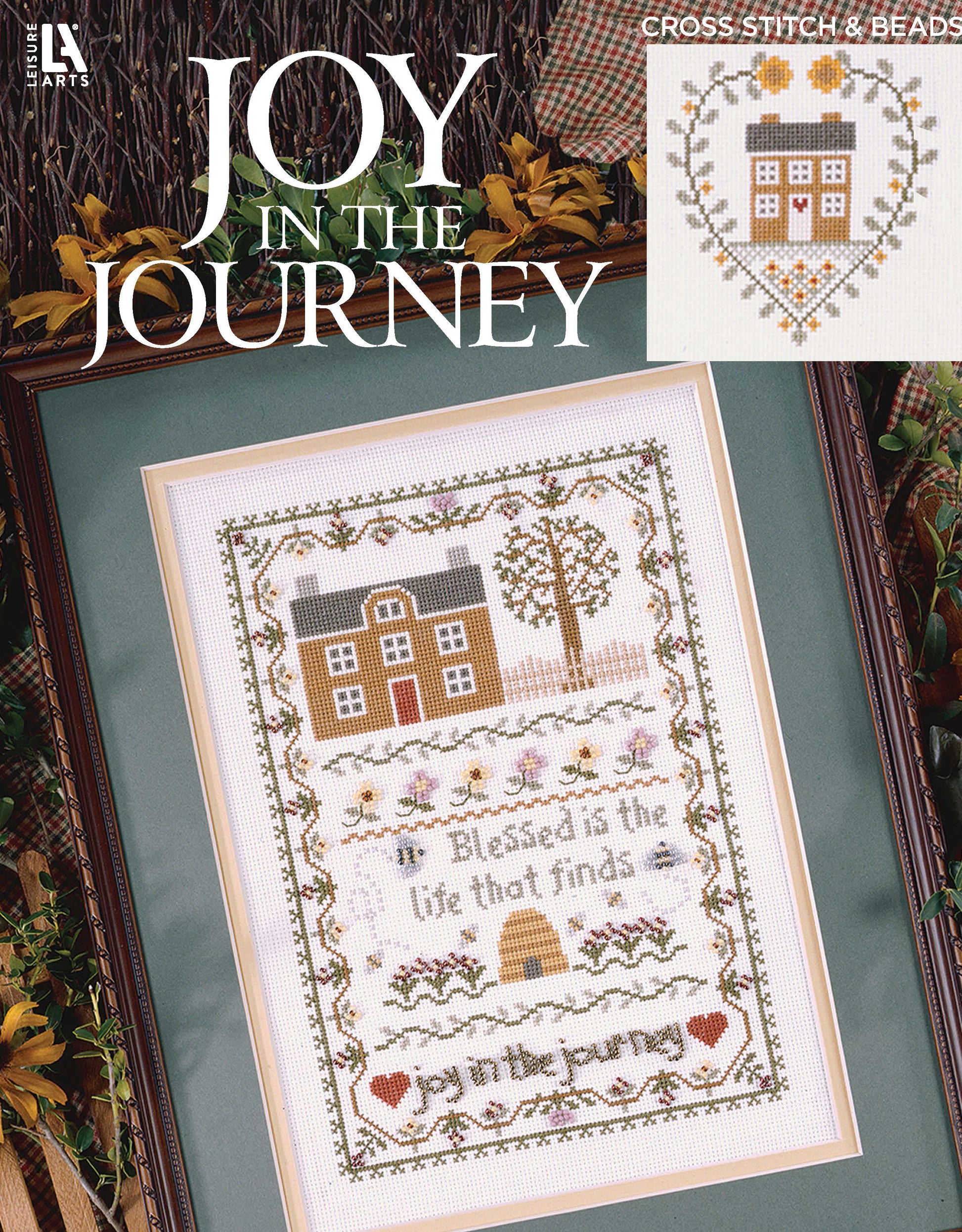 The "Joy in the Journey Digital Download" by Leisure Arts features cross stitch designs with a house, trees, flowers, "Joy in the Journey" at the top, and heart and house motifs—all as a convenient digital pattern.