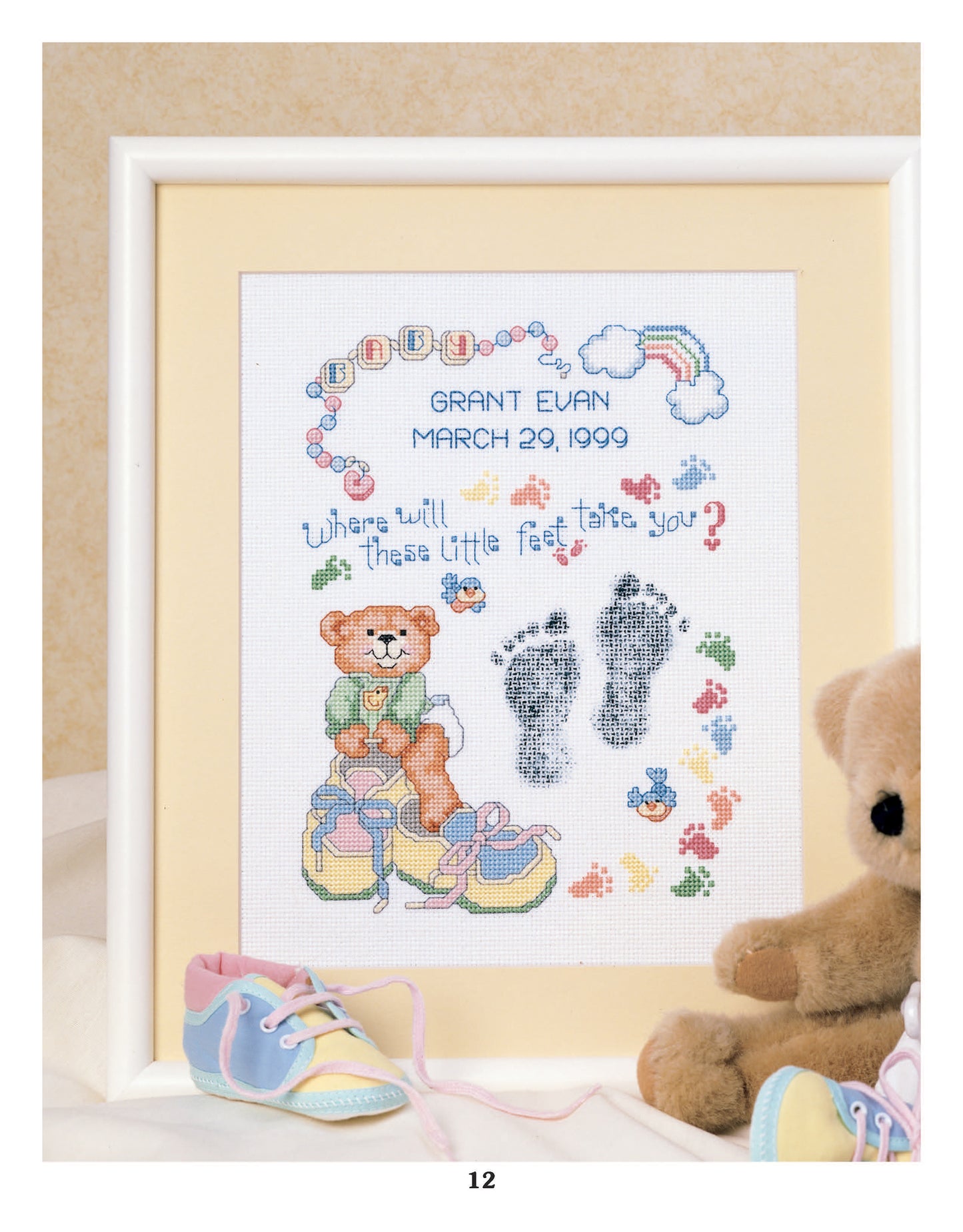 Sweet Baby Cross Stitch Memories by Leisure Arts features a framed birth announcement with a teddy bear, baby shoes, blocks, rainbow, footprints, and "GRANT EVAN MARCH 29, 1999. Where will these little feet take you?" Perfect baby keepsake.
