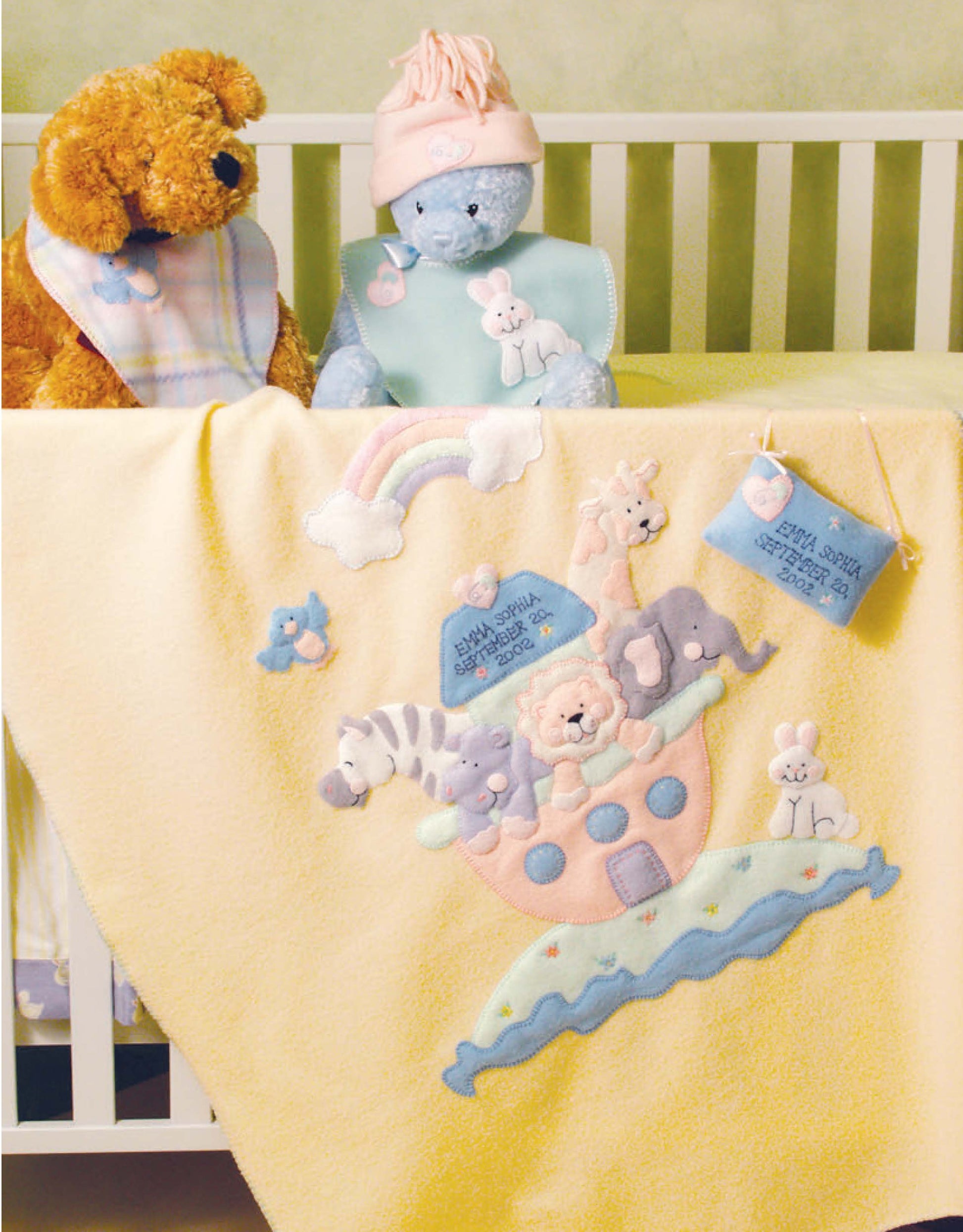 A cozy baby crib features a yellow Noah’s Ark blanket with animals and pastels, designed by Linda Gillum for Leisure Arts’ “Baby Quilts and More—18 Projects: Appliqued Fleece Quilts & Accessories” (ISBN 9781601407016).