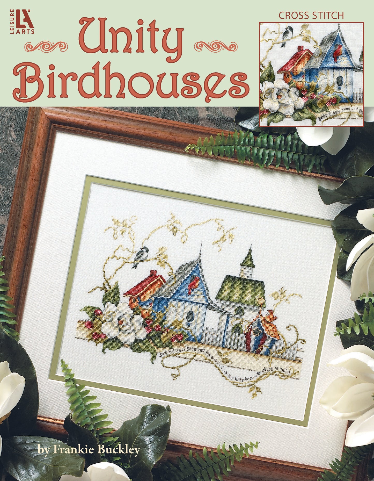 The Unity Birdhouses Cross Stitch by Leisure Arts features colorful birdhouses, flowers, and birds amid greenery and white blooms, with the text "Unity Birdhouses" and “by Frankie Buckley.” Ideal as a vibrant counted cross stitch poster.